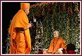 Swamishri has darshan of Shastriji Maharaj seated on a hindolo 