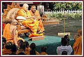 Swamishri sprays saints with the sanctified water 