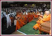 Swamishri sprays saints with the sanctified water 