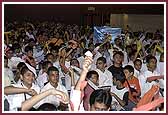  All balaks and balikas wave streamers in the air, welcoming Swamishri   