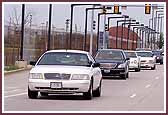 The police escort Swamishri to the mandir