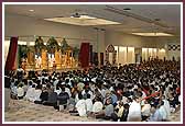 Saints and devotees seated in the morning assembly