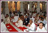 Devotees participate in the mahapuja vidhi for the murti prathistha