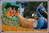 Shri Akshar Purushottam Maharaj seated on the peacock float