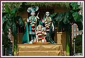 Shri Sita-Ram Dev and Hanumanji seated in a float decorated as a hut