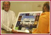 P. Yagnavallabh Swami presents a photograph of the Mandir to  CEO of Hazack Corporate Consulting, Robert Sakowit