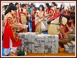 Devotees place bricks in the foundation