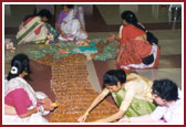 Mahila Mandal preparing beautiful artwork for Swamishri evening walk