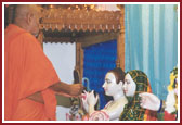 Swamishri performing idol installation of Radha Krishna