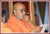 Swamishri deeply involved in reading letters from devotees