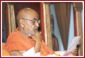 Swamishri deeply involved in reading letters from devotees