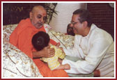 Swamishri blessing a young boy