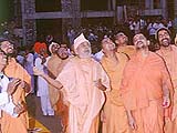 Pramukhswami momentarily catches  hold of a kite on uttarayan, much to everyones pleasure.