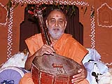 Plucking the strings of a tribal instrument,Khedbrahma
