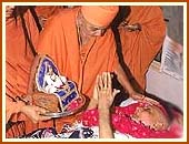 Blessing an ailing devotee
