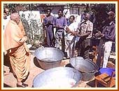 Blessing the locals who were washing the utensils, Harare, 20 Aug 99