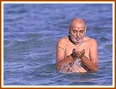 After bathing Lord Harikrishna Maharaj in the ocean waters, Swamishri prays for rain in the whole of Gujarat and offers obeisance to the sun-god. 14 Sept 99