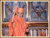 Blessing the devotees by showering rice grains during the Mahapuja