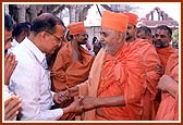 Patiently blessing a devotee after a tiring plane journey