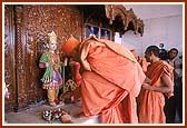 Despite the inconvenience, Swamishri patiently worships the murtis