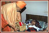 Blessing an ailing devotee with the darshan of Harikrishna Maharaj