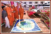 After performing the ceremony, Swamishri is seen reviewing and discussing the new site for the mandir