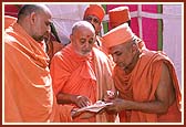 After performing the ceremony, Swamishri is seen reviewing and discussing the new site for the mandir