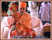 Performing Yagna rituals for the Murti pratishtha Ceremony:  Swamishri with an auspicious Kumbha