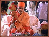 Performing Yagna rituals for the Murti pratishtha Ceremony: Swamishri with an auspicious Kumbha