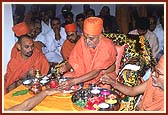 Rituals of bathing Lord Harikrishna Maharaj with water and panchamrut, prior to the Murti pratishtha ceremony