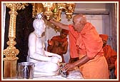 Swamishri performing abhishek (oblations) of the Lord on the first inauguration anniversary of the mandir (Patotsav)    