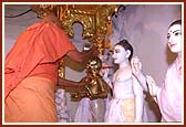 Swamishri performing abhishek (oblations) of the Lord on the first inauguration anniversary of the mandir (Patotsav)    