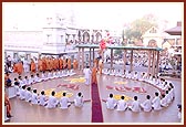 On 'Kishore Day', Swamishri was welcomed by a giant heart-shaped alignment of kishores prior to his morning puja. Walking through the 'heart' Swamishri looks up after releasing a bunch of balloons