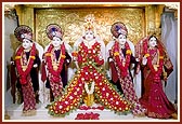 Shri Ayodhyaprasadji Maharaj, Shri Raghuvirji Maharaj, Lord Ghanshyam Maharaj adorned with flowers, Dharmadev and Bhaktimata