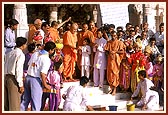At the request of volunteers Swamishri throws a ball in a bucket at the outset of Children's Day