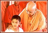 Before the central shrine Swamishri tells Akshat the name of the murtis of Harikrishna Maharaj, Lord Swaminarayan and Gunatitanand Swami ...