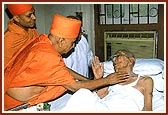 Swamishri visits a hospital blessing and reassuring an ailing, old devotee