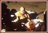 ... During which Swamishri is engrossed in reading letters in the dim light