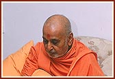  Swamishri intensely absorbed in listening to the facts and information presented&nbsp;during a meeting