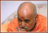  Swamishri intensely absorbed in listening to the facts and information presented&nbsp;during a meeting