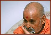  Swamishri intensely absorbed in listening to the facts and information presented&nbsp;during a meeting