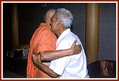 Embracing and blessing an ailing devotee