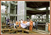 At the under construction site of a new assembly hall near the mandir