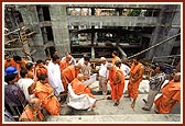 At the under construction site of a new assembly hall near the mandir