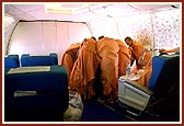 Sadhus absorbed in listening to Swamishri during the flight