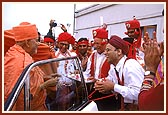 Swamishri is festively welcomed by senior devotees and youths during his arrival 