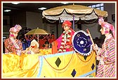 A colorful procession of Lord Harikrishna Maharaj during the evening assembly