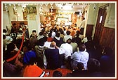 Swamishri blessing the congregation in the mandir