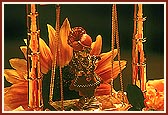 Lord Harikrishna Maharaj on a beautiful hindolo in Swamishri's morning puja