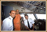 Swamishri blessing the satsangi Flight Captains - Captain Pancholi (sitting) and Captain Minesh Patel